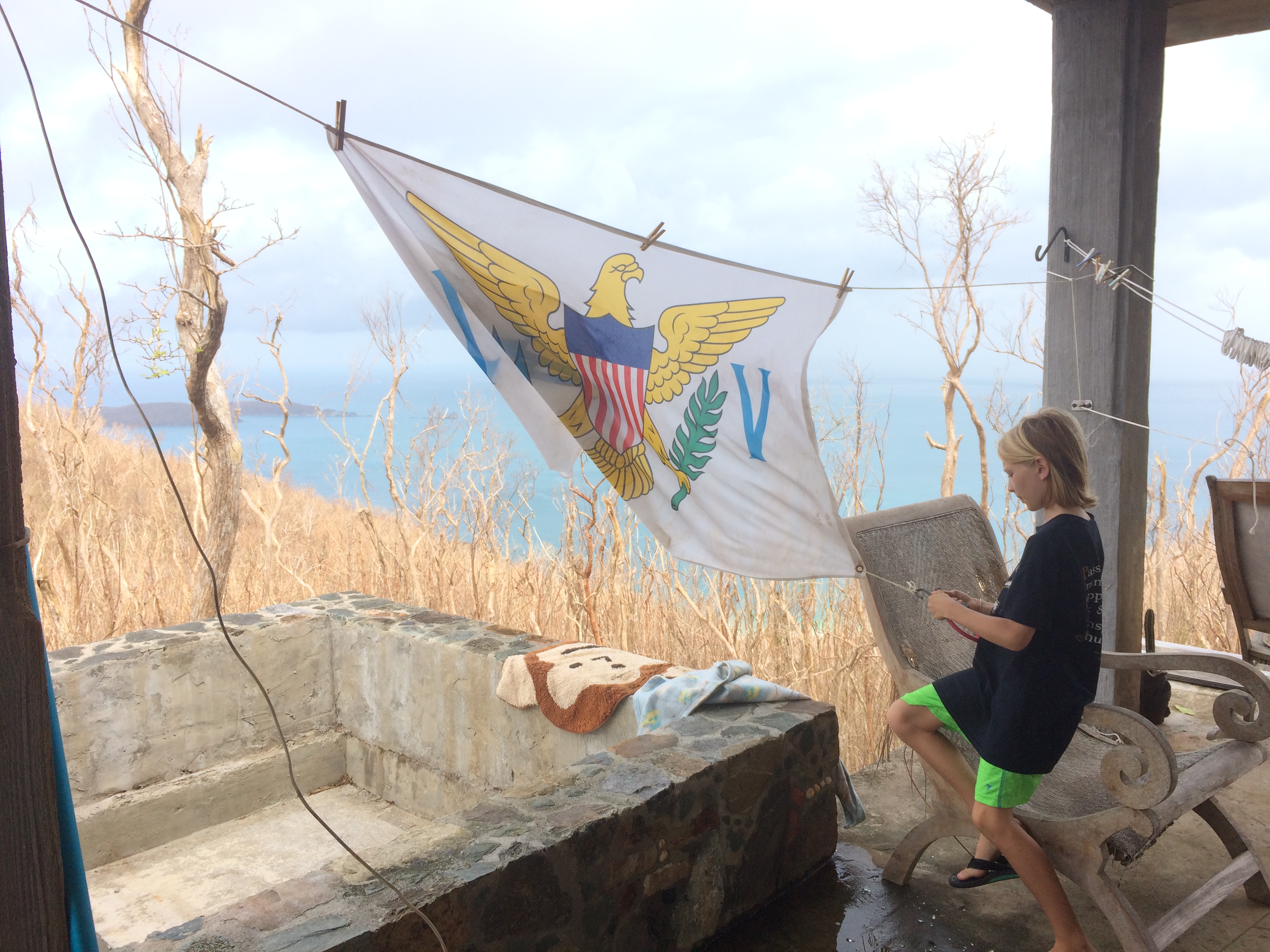 Our son stringing up the flag that used to hang in their room and was found in our neighbor’s yard after the storm. Nothing can take away our love for this place!